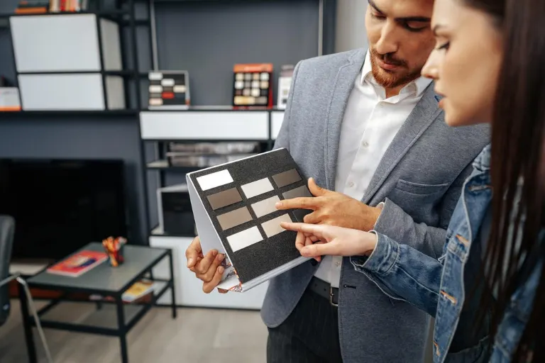 Interior designer comparing premium materials, finishes, flooring, and surfaces for a modern interior project